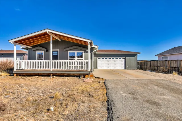 a view of a house with wooden fence