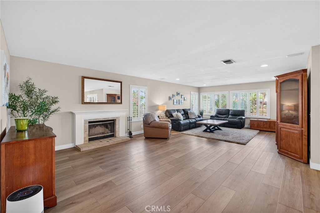 28322 Corte Ocaso Temecula, CA 92592 - Photo 22 of 75 a living room with furniture floor to ceiling window and a fireplace