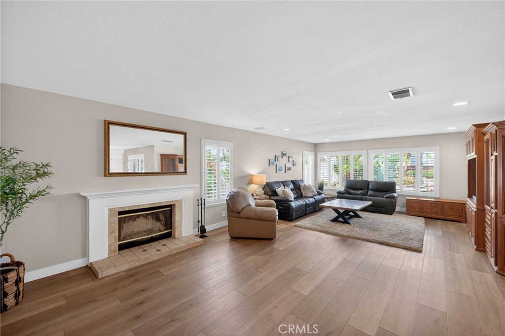 28322 Corte Ocaso Temecula, CA 92592 - Photo 23 of 75 a living room with furniture and a fireplace