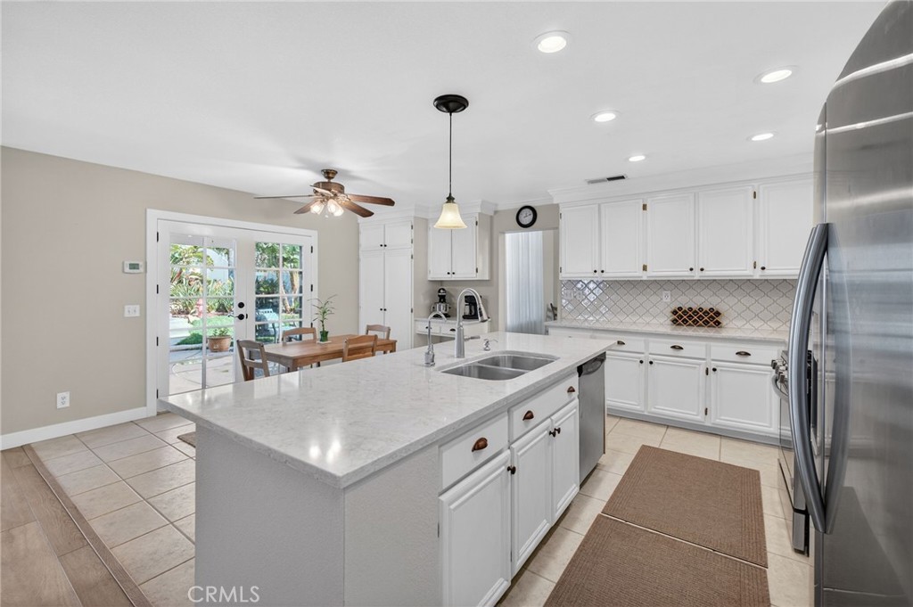 28322 Corte Ocaso Temecula, CA 92592 - Photo 32 of 75 a kitchen with stainless steel appliances kitchen island granite countertop a sink and a refrigerator