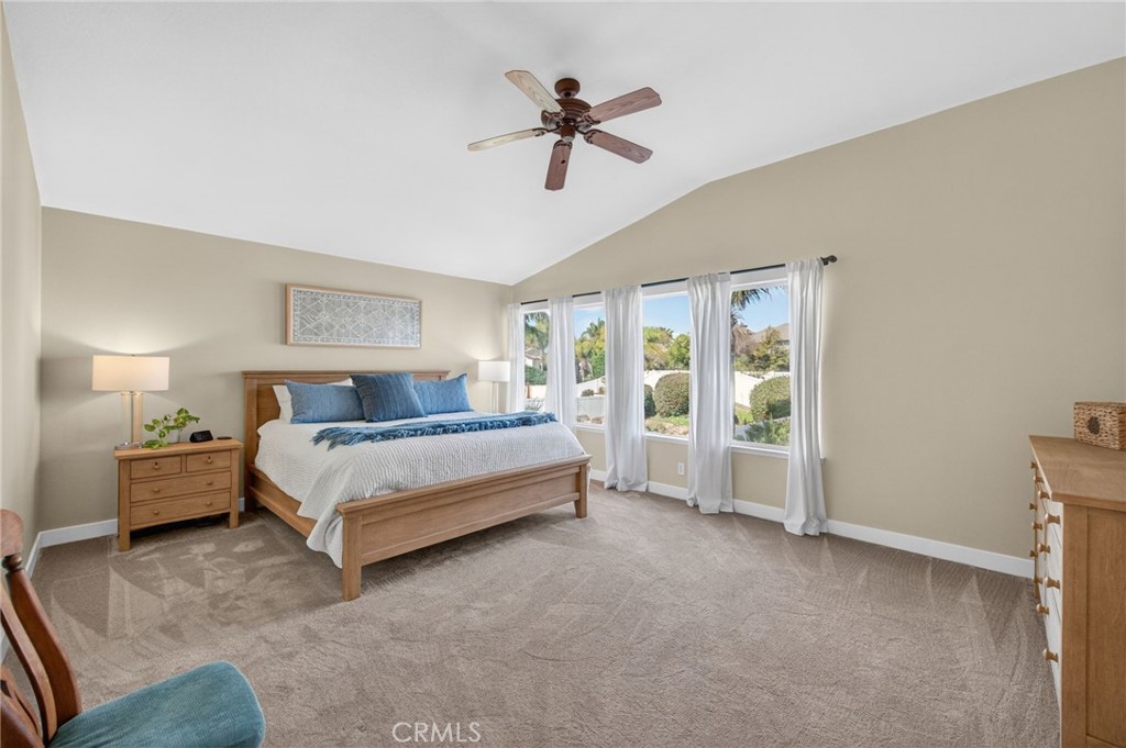 28322 Corte Ocaso Temecula, CA 92592 - Photo 43 of 75 a spacious bedroom with a bed and a chandelier