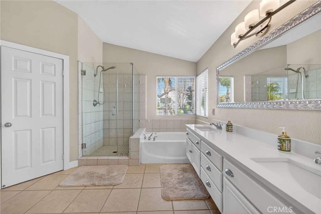 28322 Corte Ocaso Temecula, CA 92592 - Photo 48 of 75 a spacious bathroom with a granite countertop sink a toilet a mirror and shower