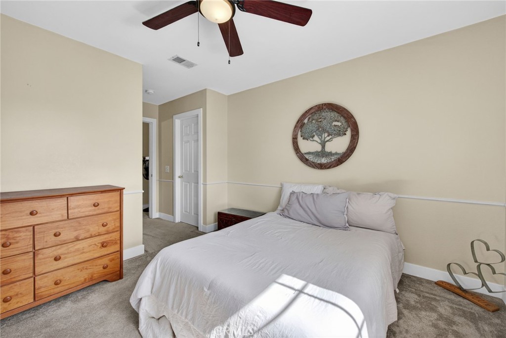 28322 Corte Ocaso Temecula, CA 92592 - Photo 53 of 75 a bedroom with a bed and a chandelier