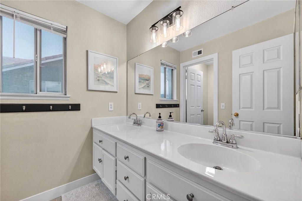 28322 Corte Ocaso Temecula, CA 92592 - Photo 54 of 75 a bathroom with double vanity sink and a mirror