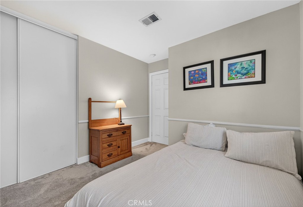 28322 Corte Ocaso Temecula, CA 92592 - Photo 57 of 75 a bedroom with a bed and a lamp on dresser