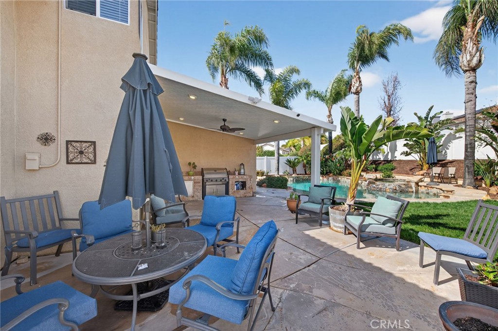 28322 Corte Ocaso Temecula, CA 92592 - Photo 65 of 75 a view of a patio with table and chairs potted plants with wooden floor