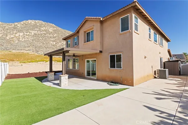 a front view of a house with garden and patio