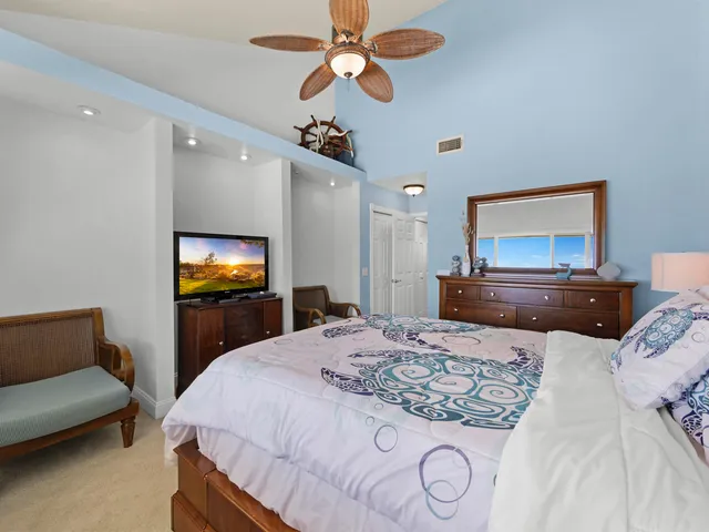 a bedroom with double bed and a chandelier