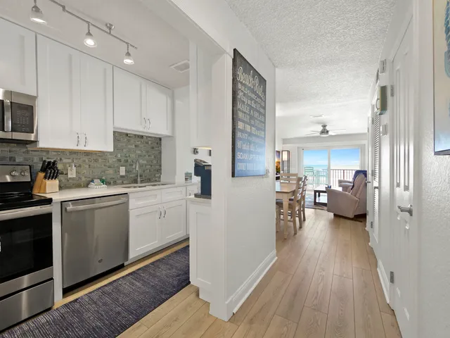 a kitchen with sink cabinets and wooden floor
