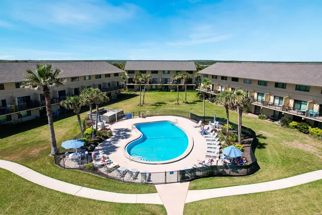 an aerial view of a house with a swimming pool