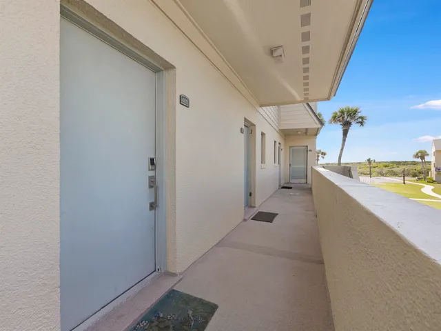 a view of a living room hardwood and the kitchen