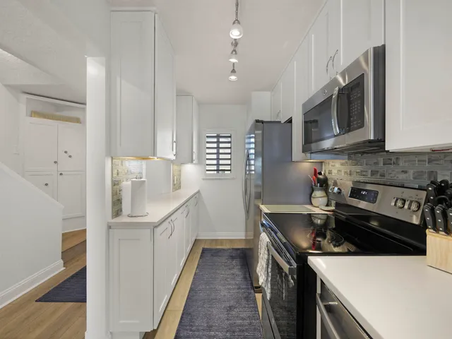 a kitchen that has a sink and a stove