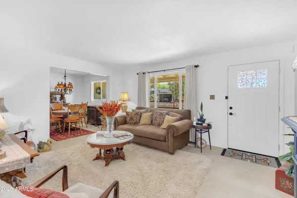 a living room with furniture and a chandelier