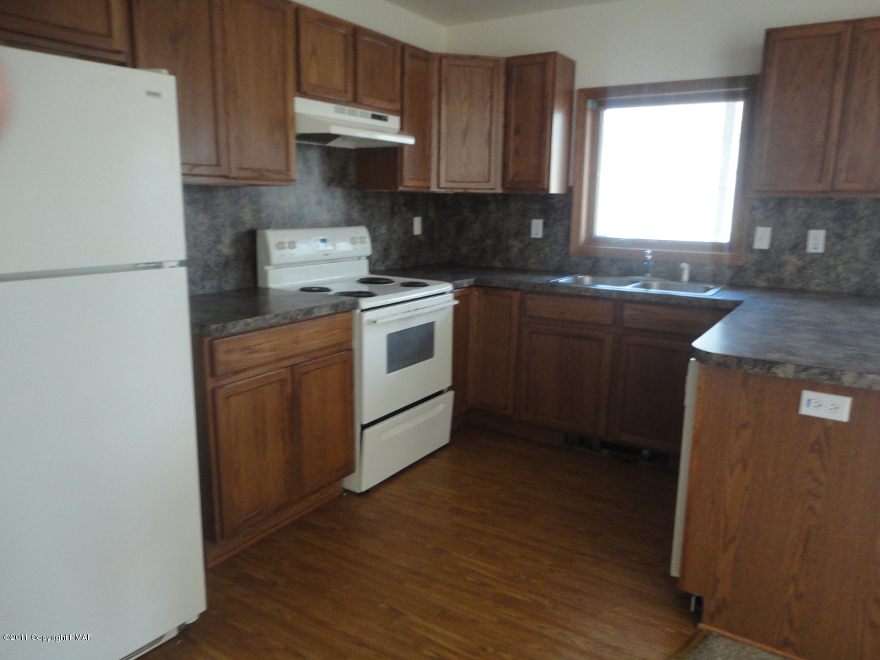 979 Canterbury Road Bushkill, PA 18324 - Photo 7 of 15 a kitchen with a sink stove and refrigerator