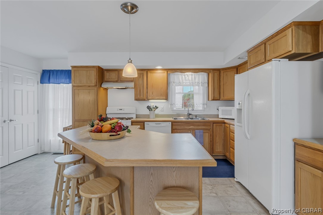 1243 Fox Point Road Reedville, VA 22539 - Photo 35 of 44 Kitchen featuring white appliances, sink, a kitchen island, and pendant lighting