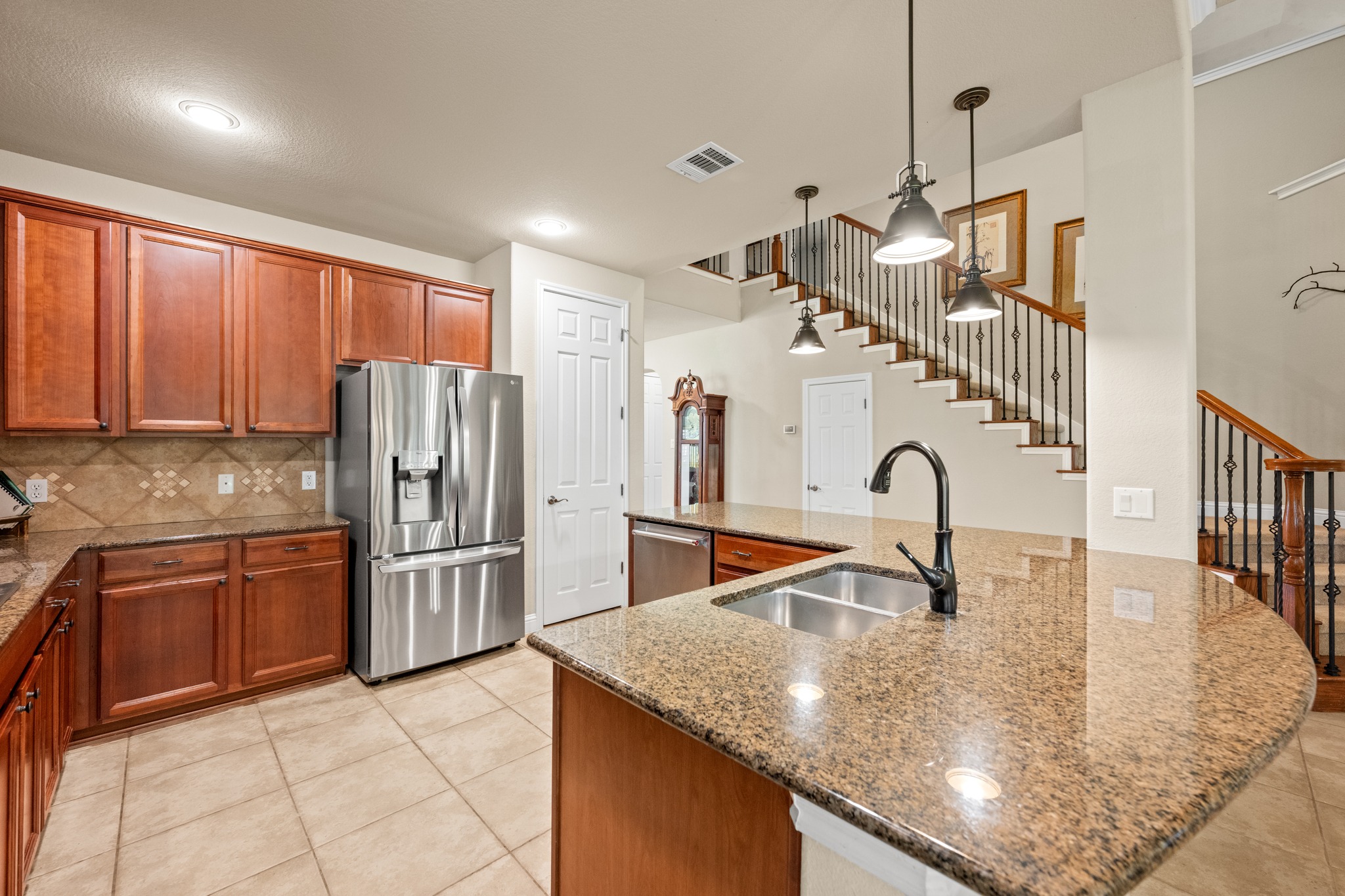 14608 Spillman Ranch Loop Austin, TX 78738 - Photo 10 of 31 a kitchen with stainless steel appliances granite countertop a sink refrigerator and cabinets