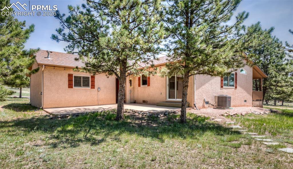 2602 Southpark Road Florissant, CO 80816 - Photo 11 of 50 L-shaped concrete back patio. that walks out from the kitchen for more space to enjoy the lovely scenery.