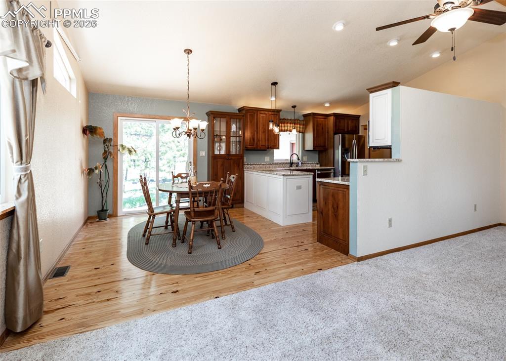 2602 Southpark Road Florissant, CO 80816 - Photo 16 of 50 Living room into dining and kitchen. Perfect floorplan for family activities and entertaining.