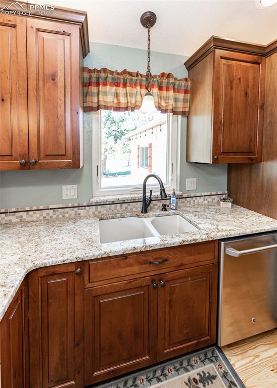 2602 Southpark Road Florissant, CO 80816 - Photo 18 of 50 Granite countertops with stylized tile backsplash. Enjoy the outdoors while you work at the sink.