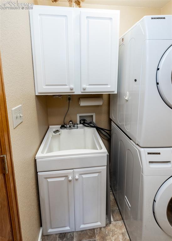 2602 Southpark Road Florissant, CO 80816 - Photo 24 of 50 Stack washer and dryer and convenient laundry sink and cabinets.