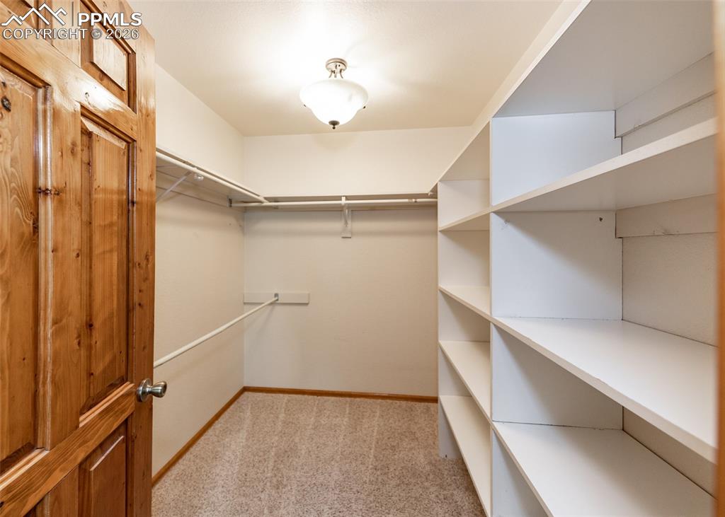 2602 Southpark Road Florissant, CO 80816 - Photo 32 of 50 Primary suite walk-in closet with ample shelving and hanging areas.