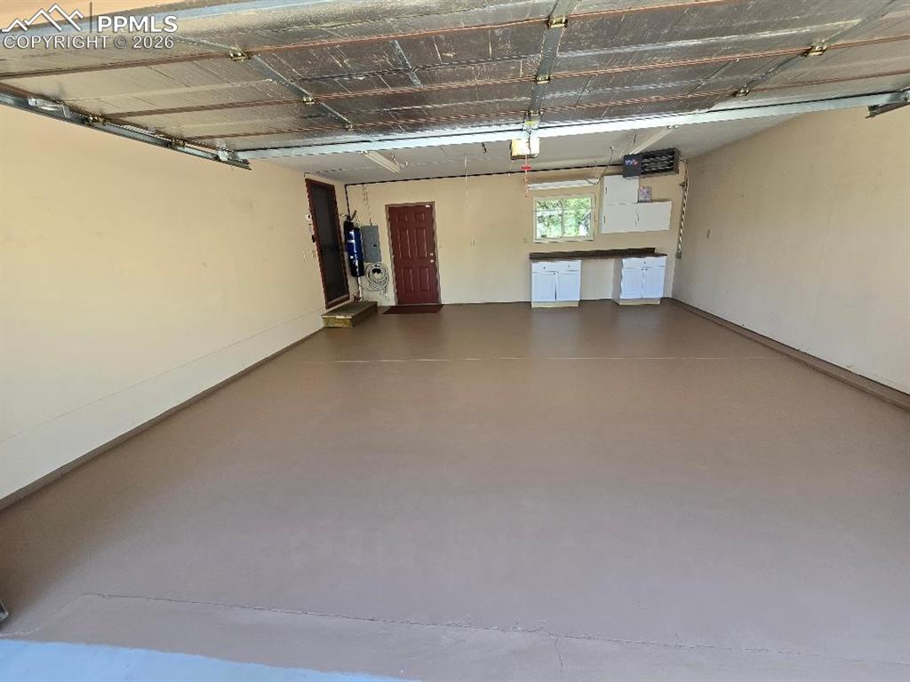 2602 Southpark Road Florissant, CO 80816 - Photo 39 of 50 Heated attached garage with work area. Has newly painted floors and attic storage with pull down stairway.