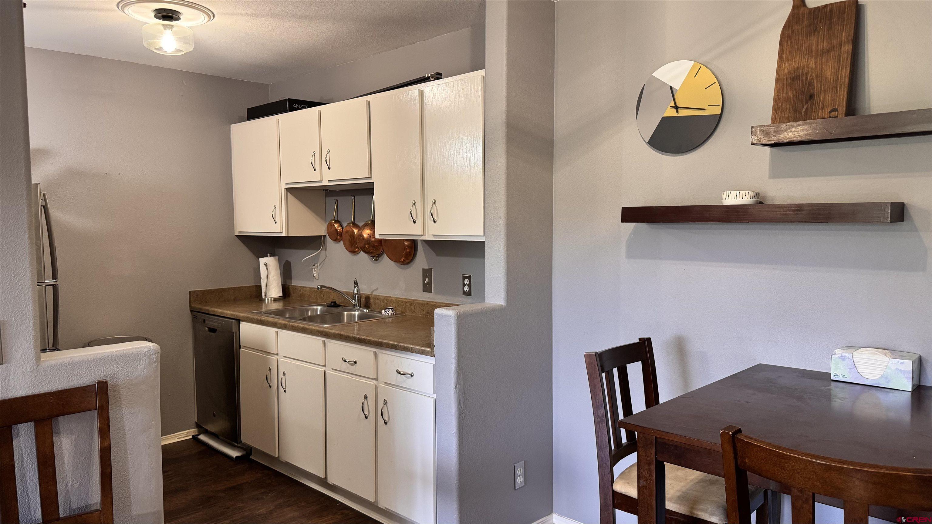 1100 Goeglein Gulch Road, Unit 204 Durango, CO 81301 - Photo 13 of 42 a kitchen with stainless steel appliances granite countertop a stove a sink and a microwave