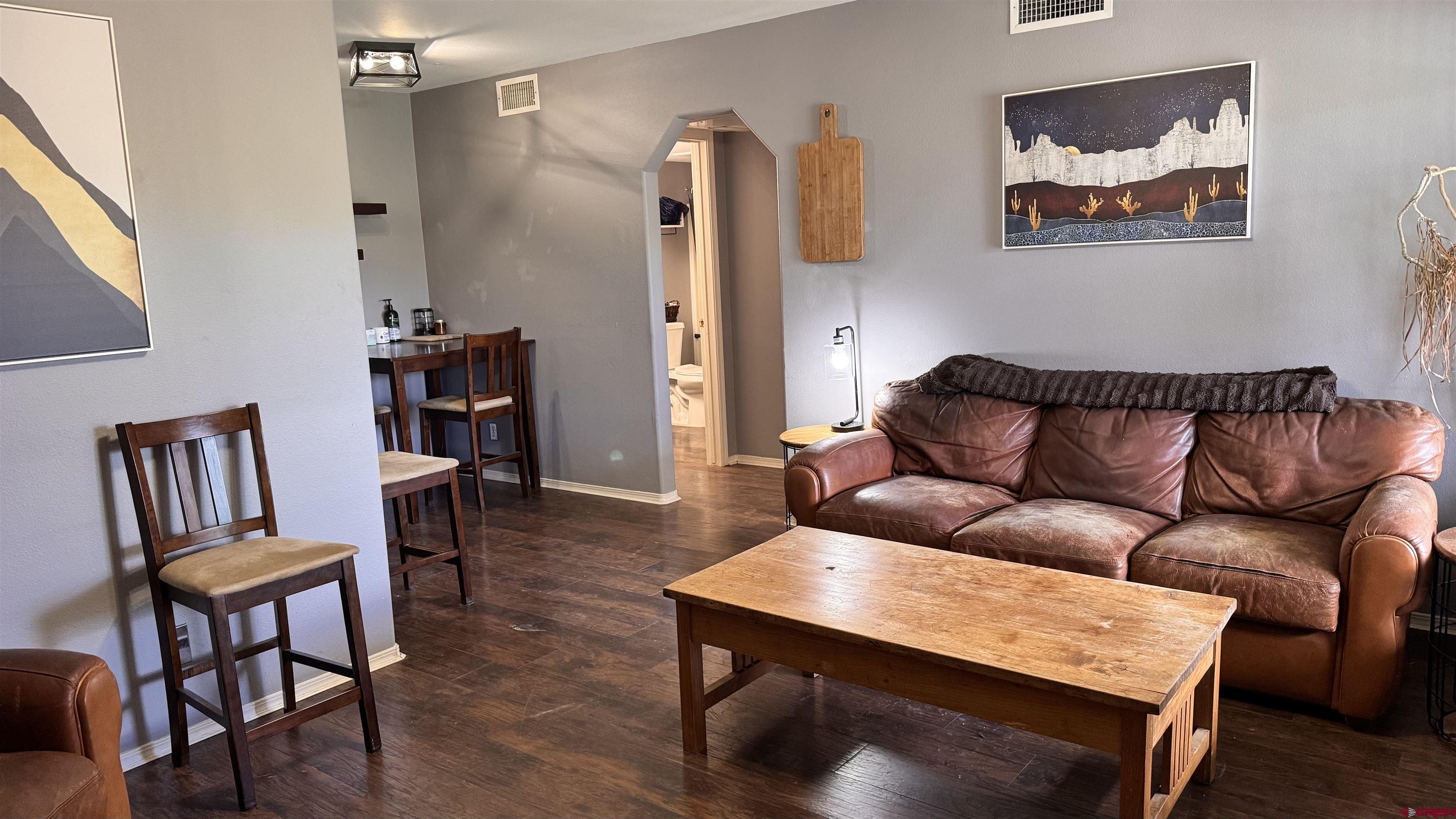 1100 Goeglein Gulch Road, Unit 204 Durango, CO 81301 - Photo 4 of 42 a living room with furniture and a wooden floor