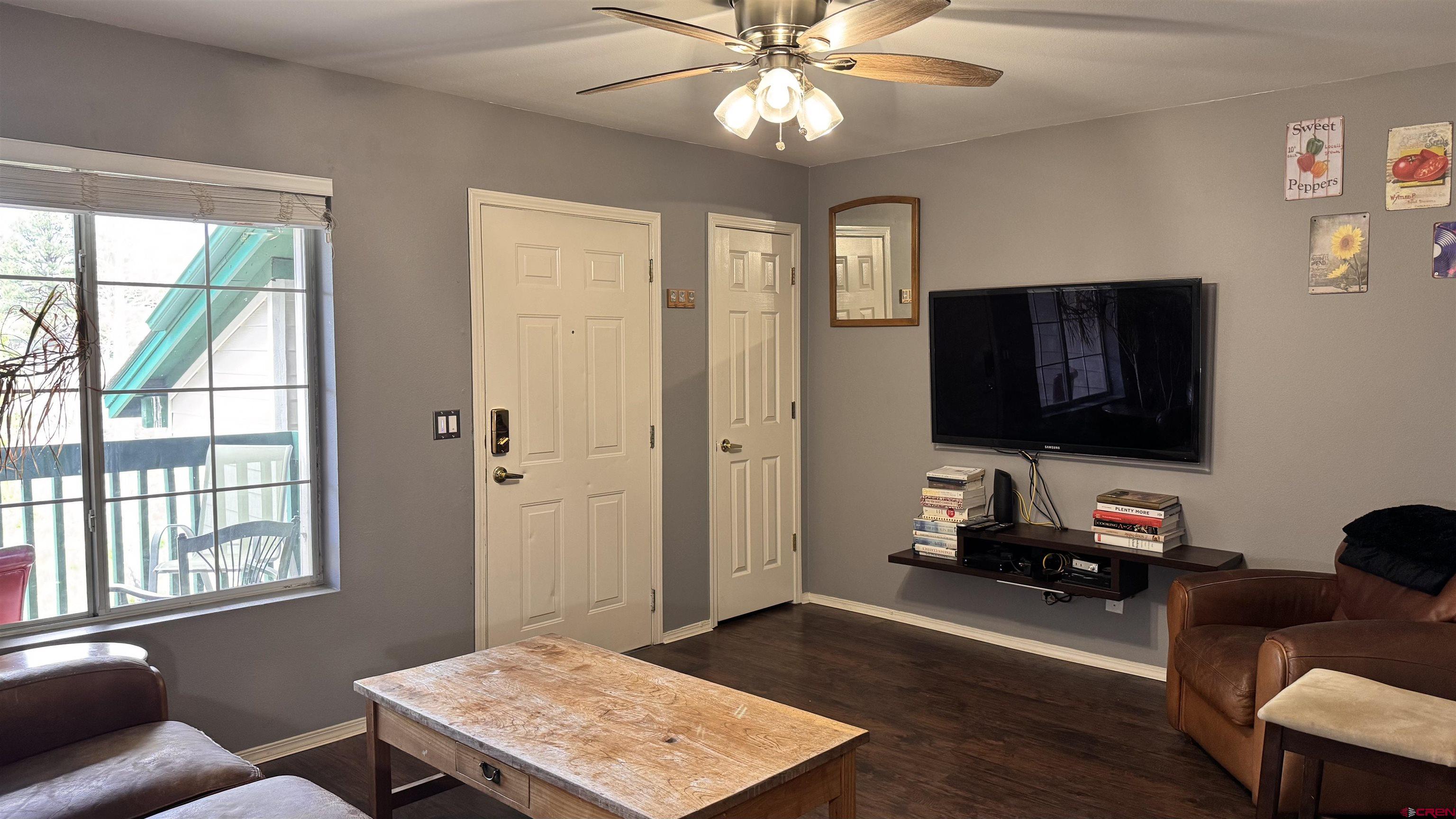 1100 Goeglein Gulch Road, Unit 204 Durango, CO 81301 - Photo 5 of 42 a living room with furniture and a flat screen tv