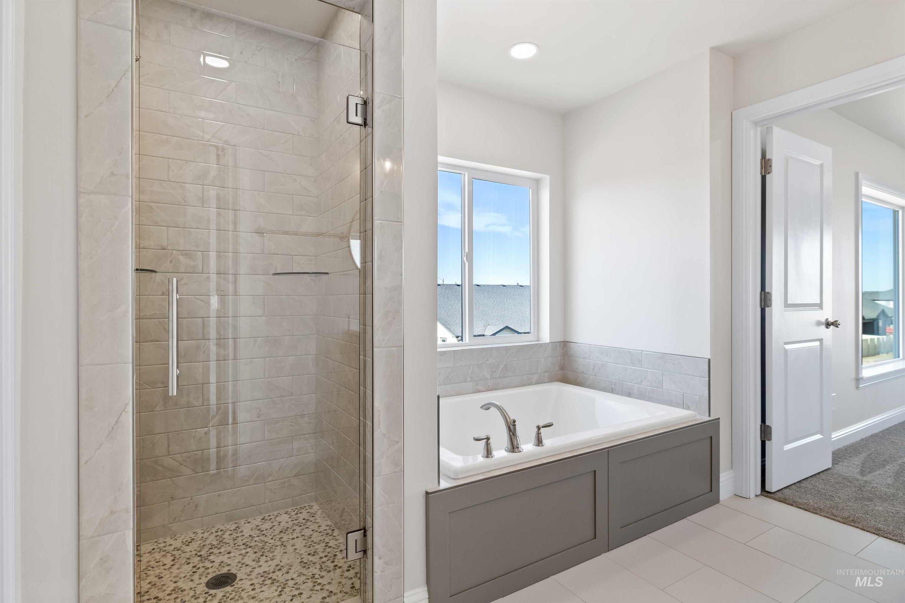 867 Adamite Road Kimberly, ID 83341 - Photo 13 of 24 Full bath featuring a stall shower, a garden tub, recessed lighting, a water view, and tile patterned floors