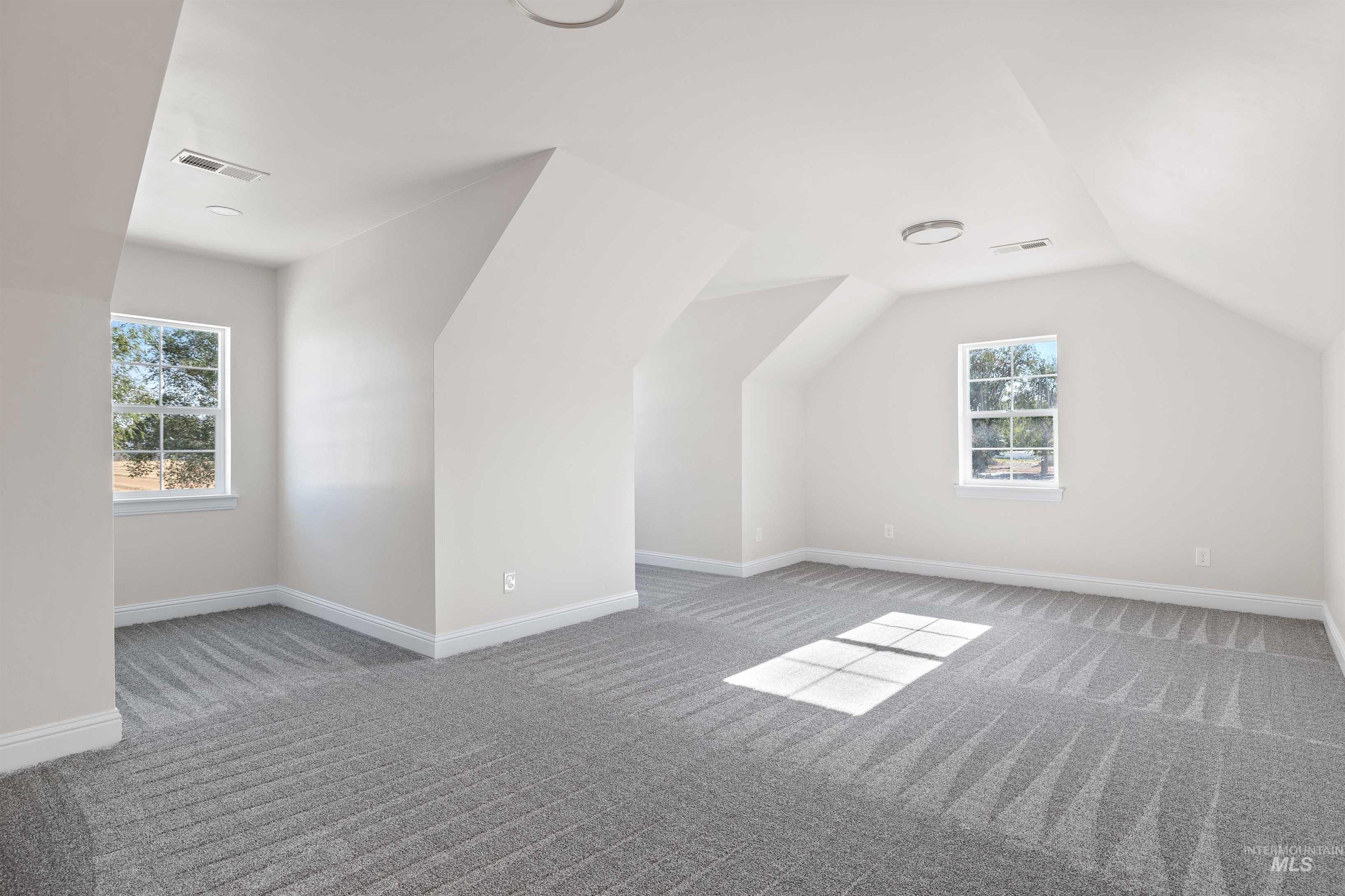 867 Adamite Road Kimberly, ID 83341 - Photo 17 of 24 Bonus room featuring carpet and lofted ceiling