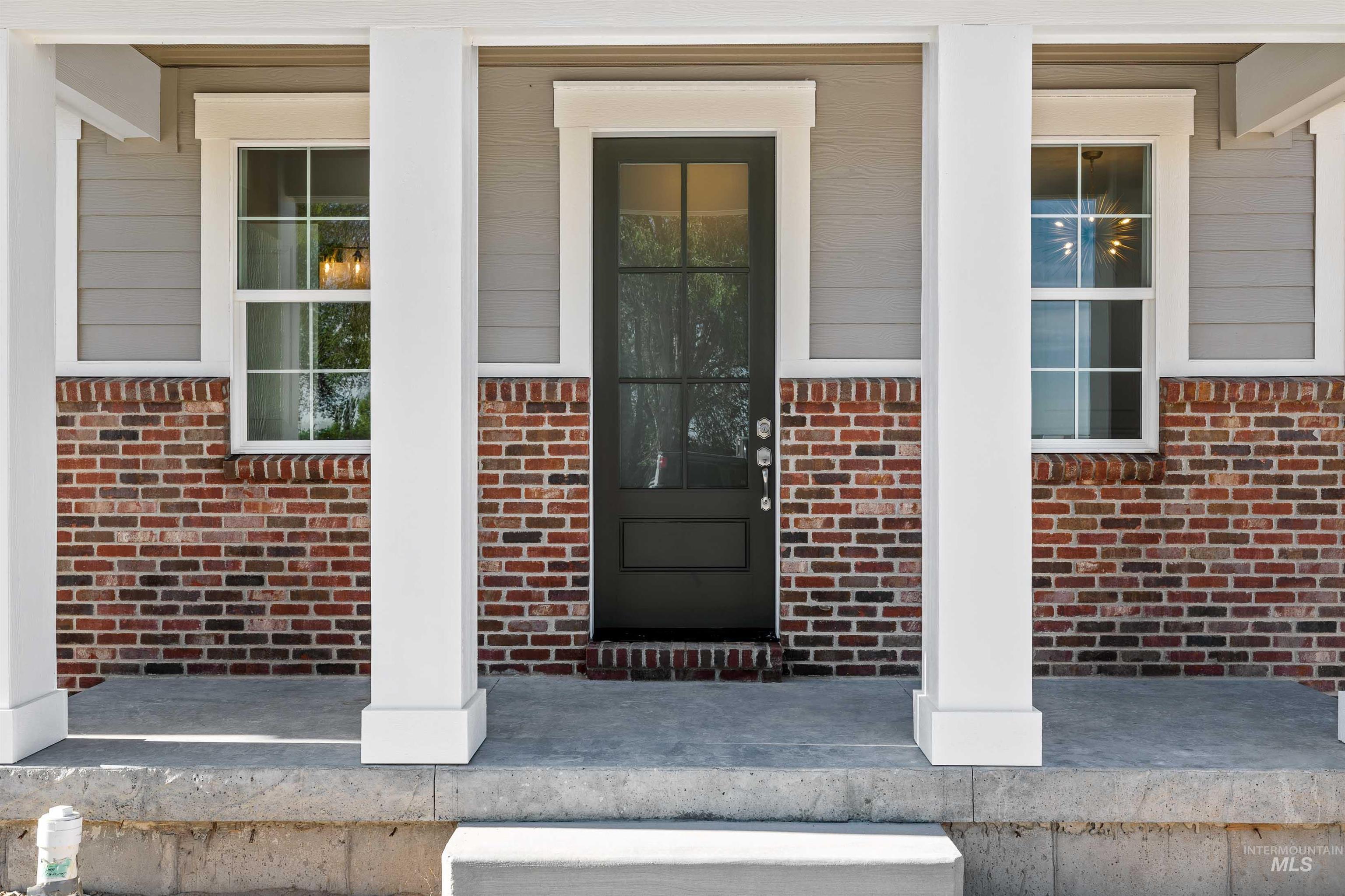 867 Adamite Road Kimberly, ID 83341 - Photo 2 of 24 View of exterior entry featuring a porch and brick siding