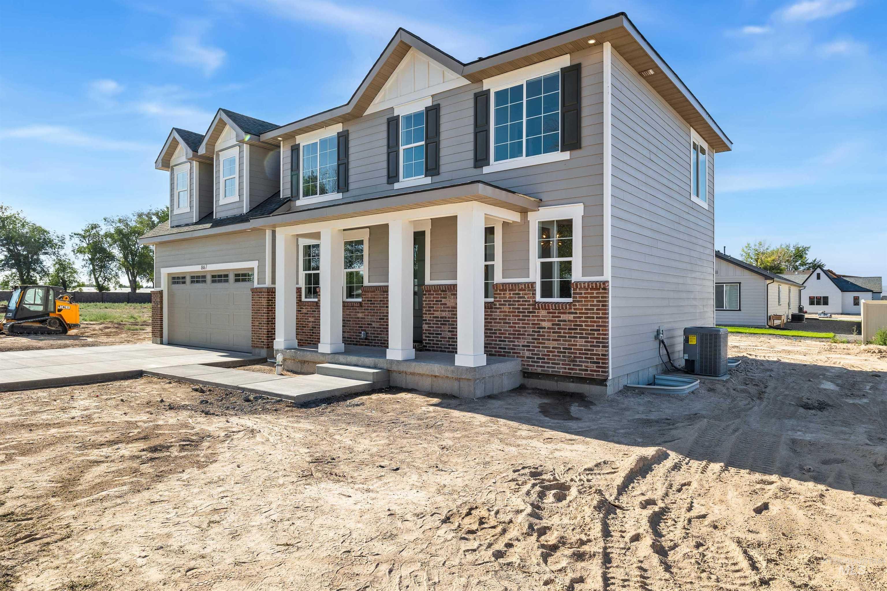 867 Adamite Road Kimberly, ID 83341 - Photo 23 of 24 Craftsman inspired home featuring a porch, driveway, brick siding, and a garage