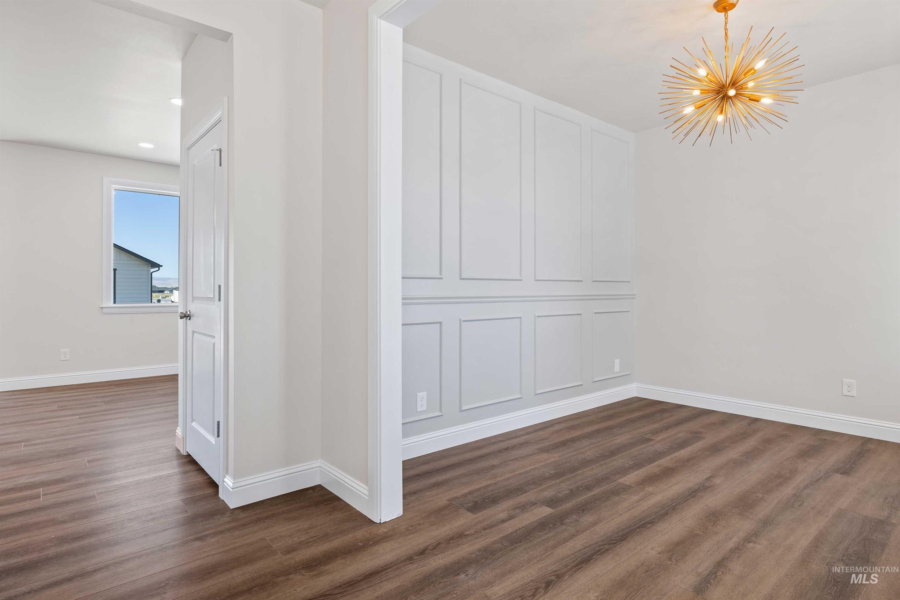 867 Adamite Road Kimberly, ID 83341 - Photo 5 of 24 Empty room featuring a chandelier, dark wood-type flooring, and recessed lighting