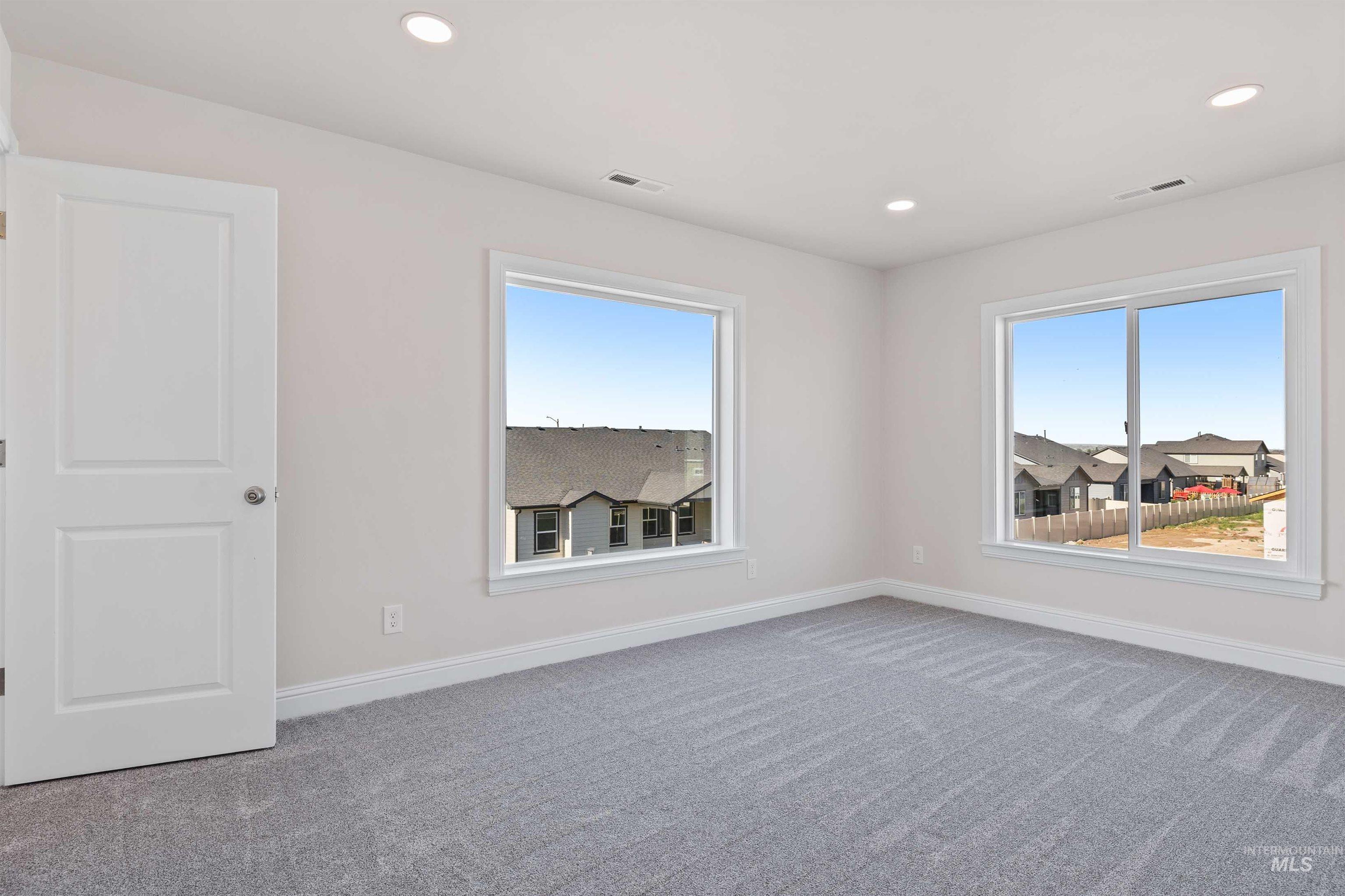867 Adamite Road Kimberly, ID 83341 - Photo 9 of 24 Carpeted empty room with plenty of natural light and recessed lighting