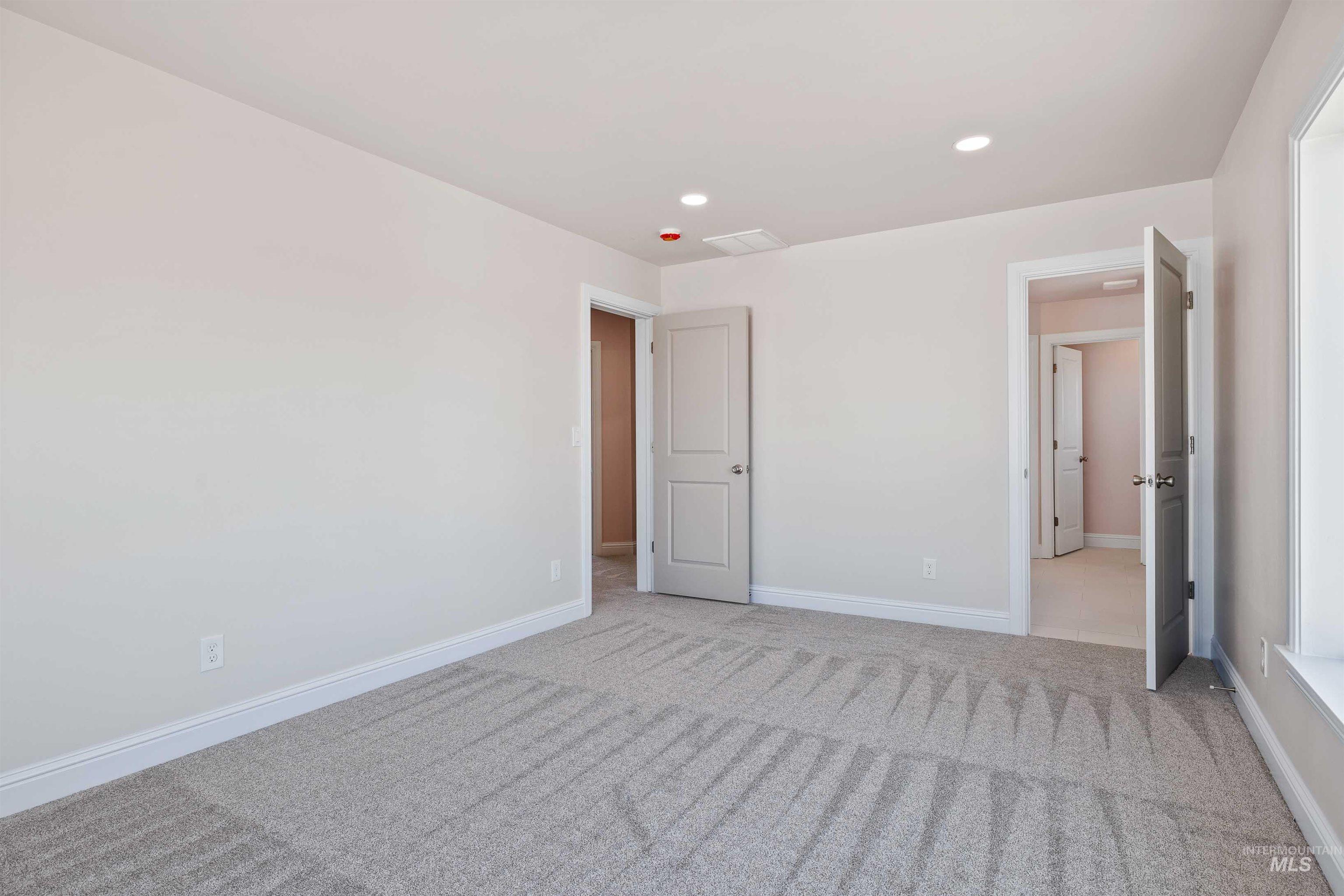 867 Adamite Road Kimberly, ID 83341 - Photo 10 of 24 Unfurnished bedroom with light colored carpet and recessed lighting