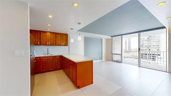 a kitchen with stainless steel appliances granite countertop a refrigerator a sink and a large window