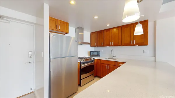 a kitchen with stainless steel appliances granite countertop a refrigerator and a sink