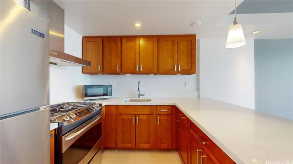 a kitchen with a sink a stove and cabinets