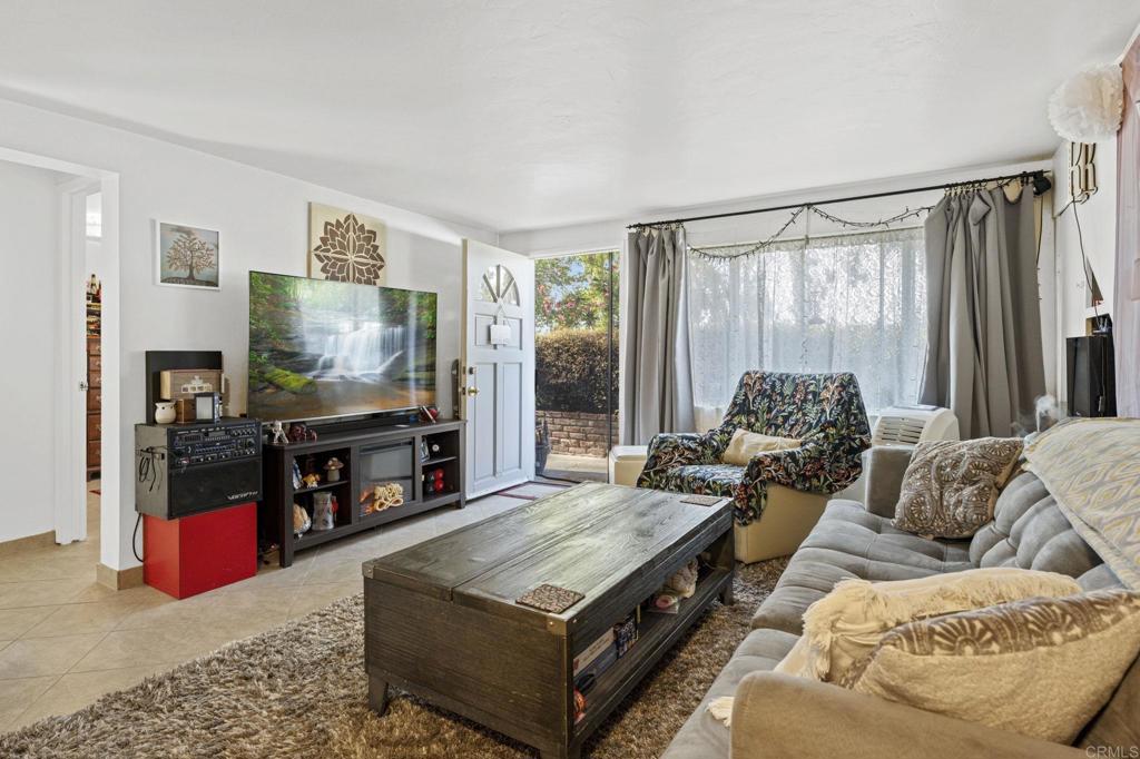 841 Normandy Road Encinitas, CA 92024 - Photo 4 of 38 a living room with furniture and a flat screen tv