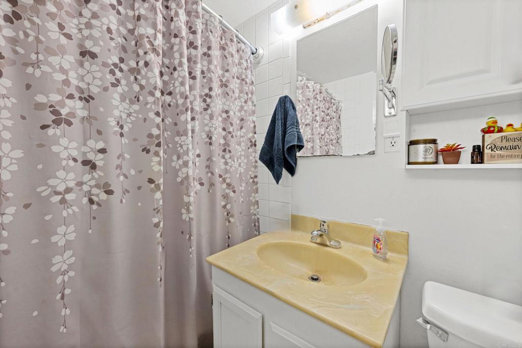 841 Normandy Road Encinitas, CA 92024 - Photo 9 of 38 a bathroom with a sink and a toilet