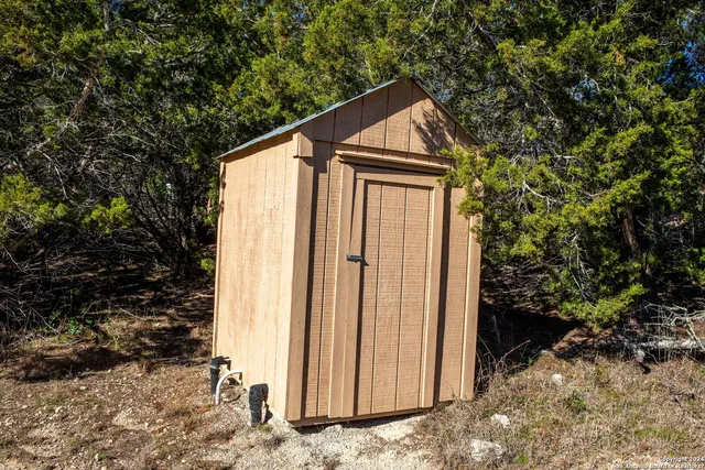 a backyard of a house with table and chairs