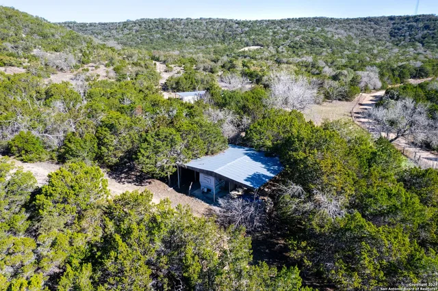 an aerial view of a house with a yard