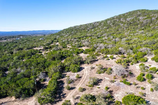 a view of a yard with wooden fence