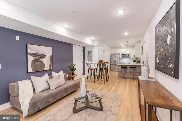 a living room with furniture and kitchen view