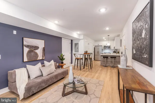 a living room with furniture and kitchen view