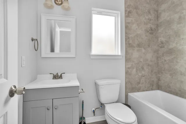 a bathroom with a toilet sink and bathtub