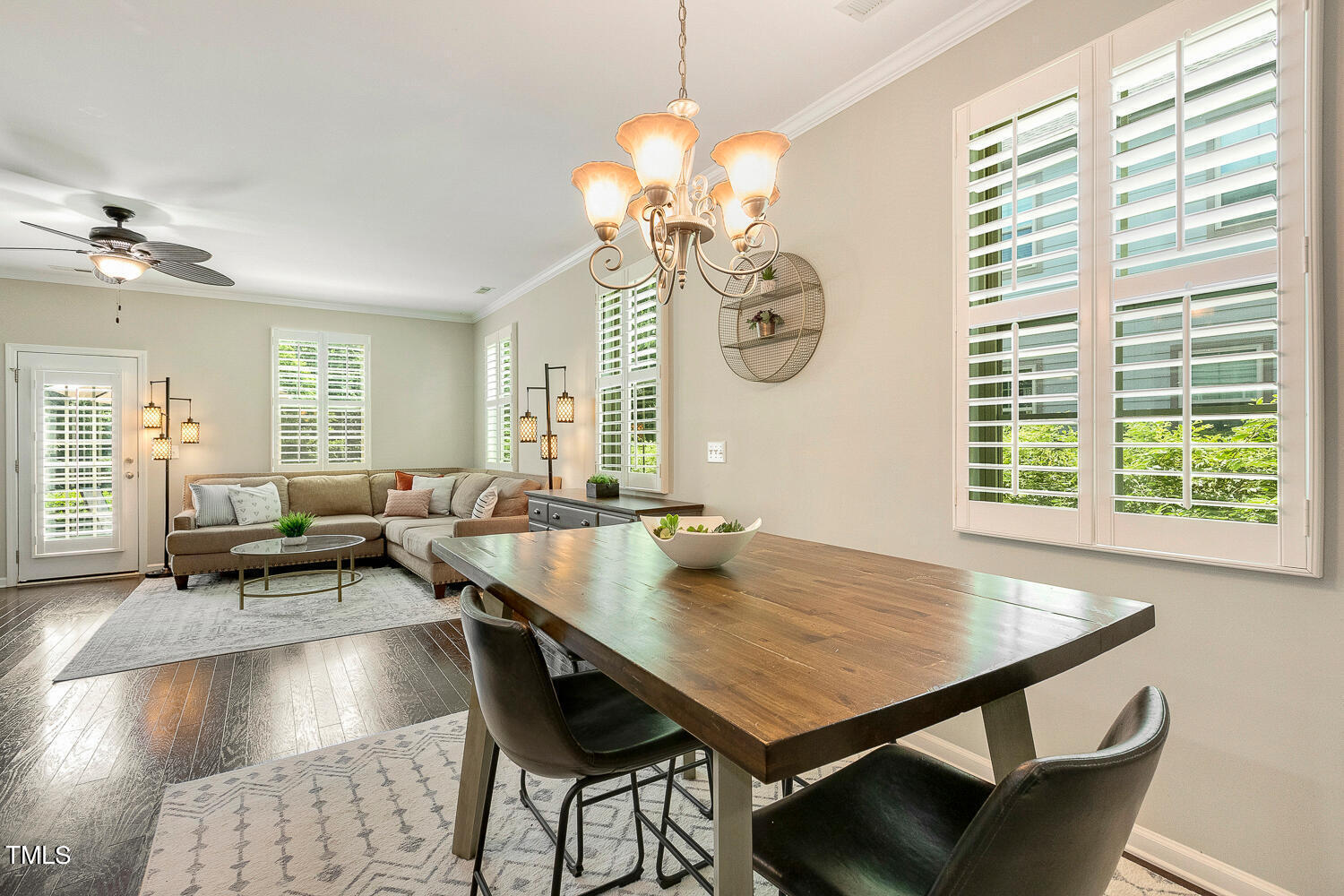 2425 Baslow Drive Apex, NC 27539 - Photo 14 of 48 a view of a dining room and livingroom with furniture wooden floor a rug a potted plant and a chandelier