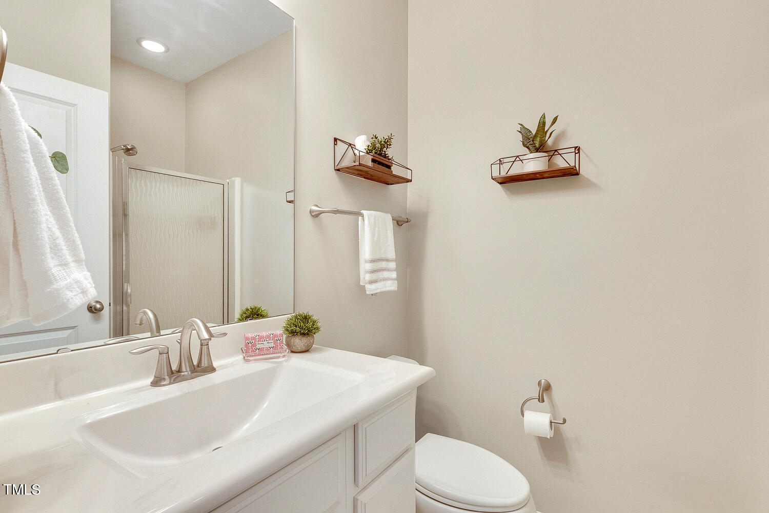 2425 Baslow Drive Apex, NC 27539 - Photo 22 of 48 a bathroom with a sink vanity mirror and toilet