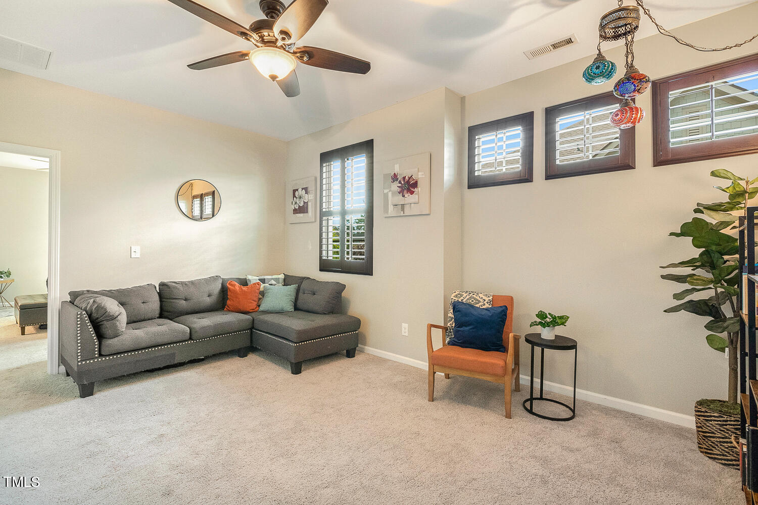 2425 Baslow Drive Apex, NC 27539 - Photo 26 of 48 a living room with furniture and a potted plant